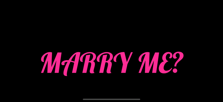 MARRY ME? in pink script font on a fullscreen black background